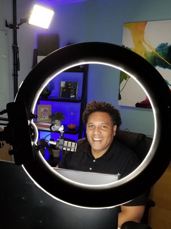 Nick at his desk framed by a ring light