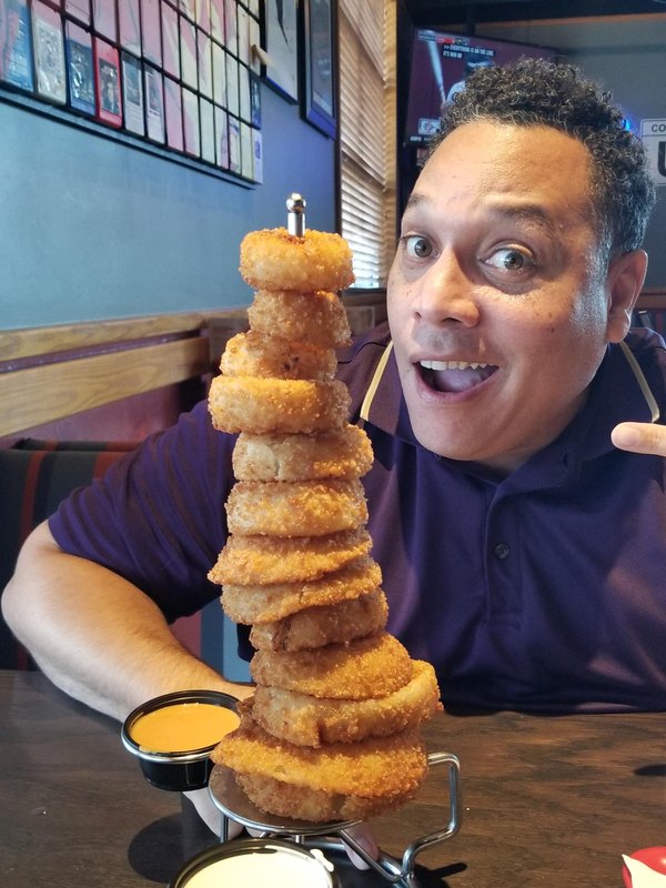 Nick with a towering stack of onion rings